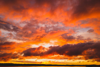 Scenic view of dramatic sky over sea during sunset