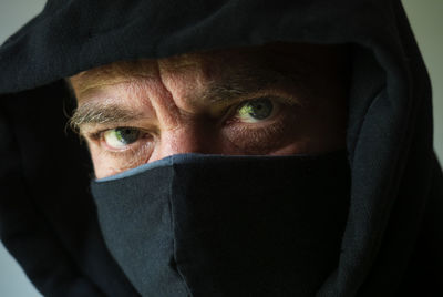 Close-up portrait of mid adult man covering face