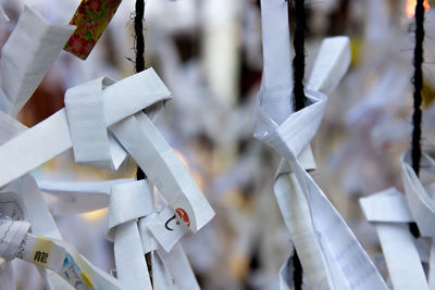 Close-up of clothespins hanging on fence