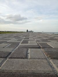Surface level of airport runway against sky