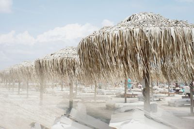 Thatched roofs at beach during winter