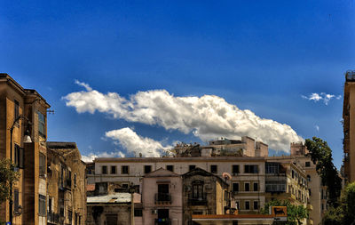 Low angle view of building against cloudy sky