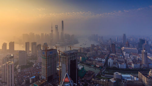 Scenic view of cityscape in foggy weather