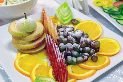Close-up of fruits in plate on table