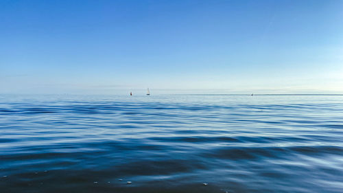 Scenic view of sea against clear blue sky