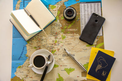Planing vacation with map, notebook, coffee and passport
