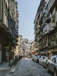 Street amidst buildings against sky in city