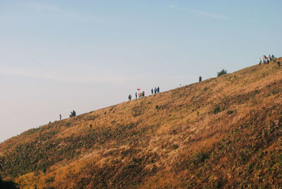 People on mountain road against sky