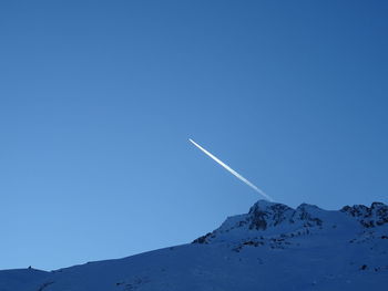 Scenic view of snowcapped mountains against clear blue sky