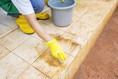 Low section of man working on tiled floor