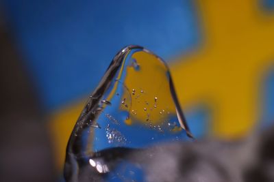 Melting ice cube with swedish colours