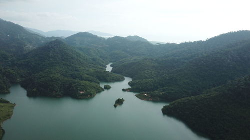 High angle view of river amidst mountains against sky