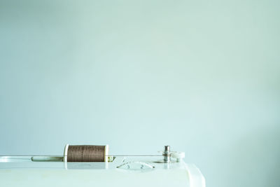 Close-up of wooden table against blue background