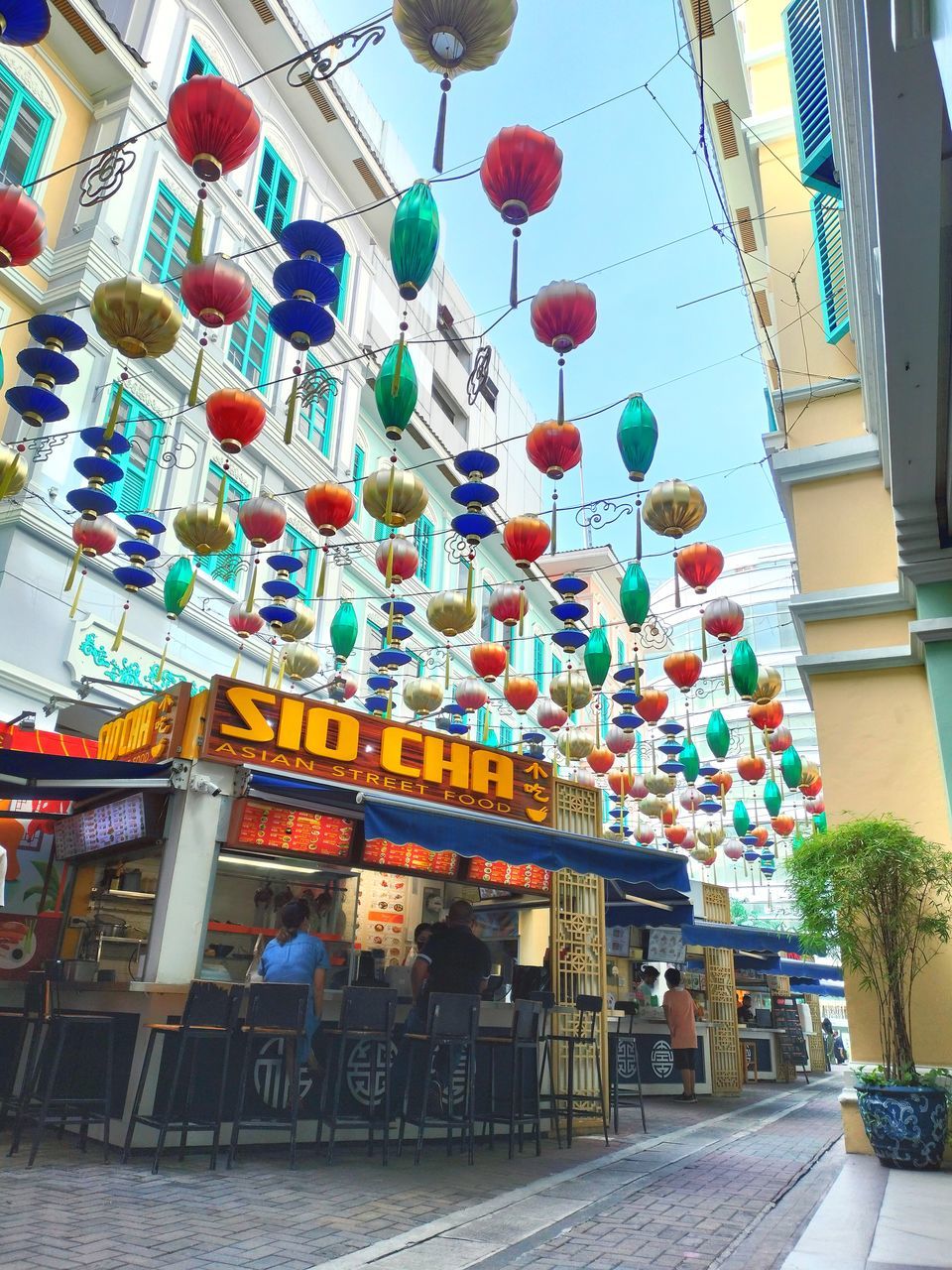 architecture, lantern, built structure, decoration, building exterior, hanging, lighting equipment, multi colored, city, celebration, chinese lantern, tradition, no people, building, low angle view, street, day, outdoors, travel destinations, nature, holiday, event