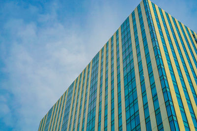 Low angle view of modern building against blue sky