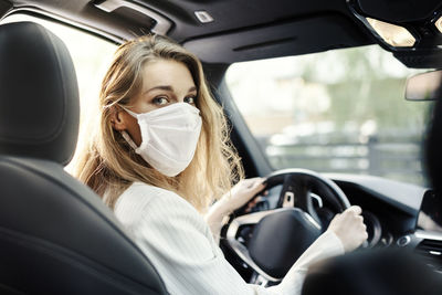 Portrait of woman sitting in car