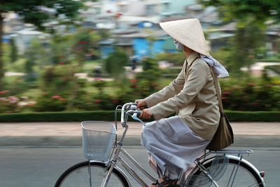 Side view of man riding bicycle