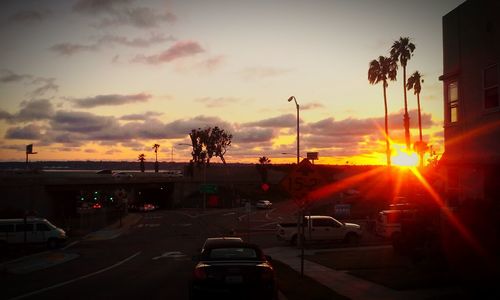 Traffic on road at sunset