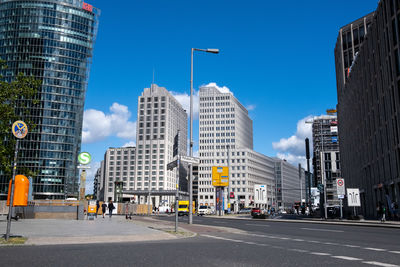 City street and buildings against sky