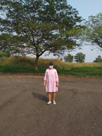 Rear view of woman walking on road