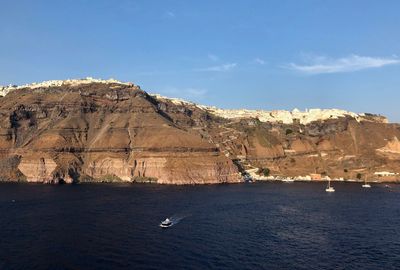 Scenic view of sea and mountains against sky