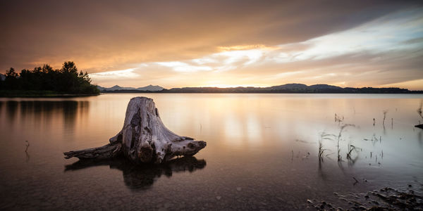 Scenic view of lake against sky during sunset