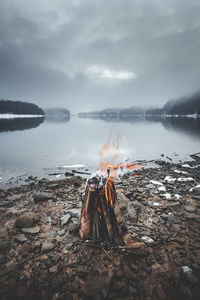 High angle view of bonfire by lake during winter