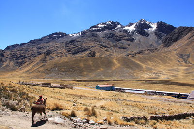 Scenic view of mountains against blue sky