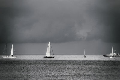 Sailboat sailing on sea against sky