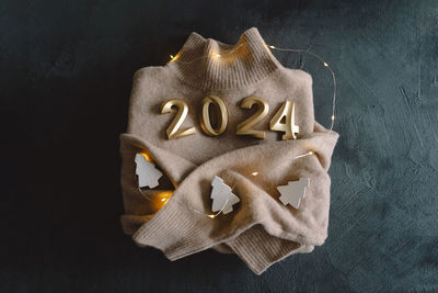 Holiday background happy new year 2024. numbers of year 2024 with sweater