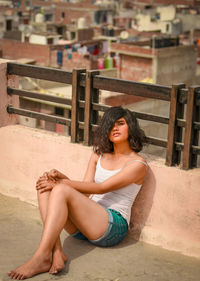 Portrait of young woman sitting on terrace