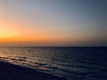 Scenic view of sea against clear sky during sunset