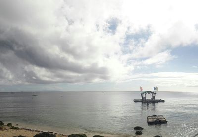 Scenic view of sea against cloudy sky