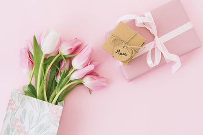 Cropped hand of woman holding gift box on table