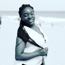 Portrait of woman standing at beach