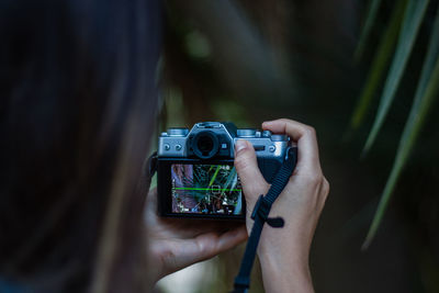 Close-up of woman photographing through camera