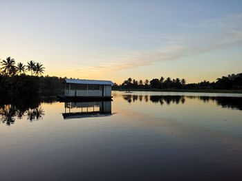 Scenic view of lake against sky at sunset