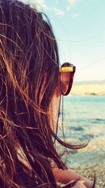 Woman looking at sea against sky