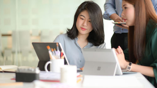 Young woman using laptop on table