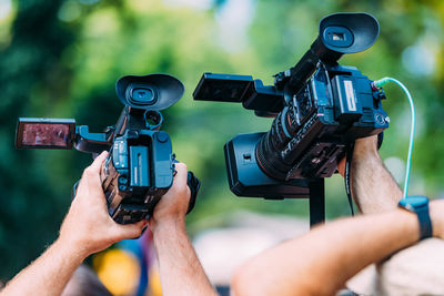 Cameras at a media conference outdoors.