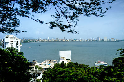 Boat on sea with city in background