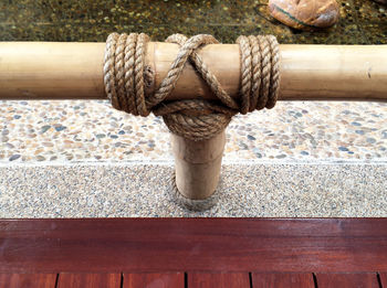 Close-up of rope tied on wood