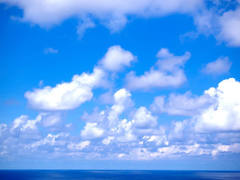 Low angle view of sea against blue sky