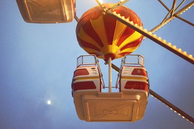 Low angle view of illuminated lights at sunset