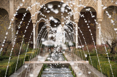 Water splashing on fountain against building