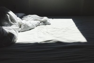 Crumpled sheet on bed at home