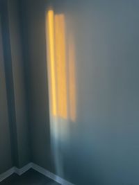 Close-up of curtain against window at sunset