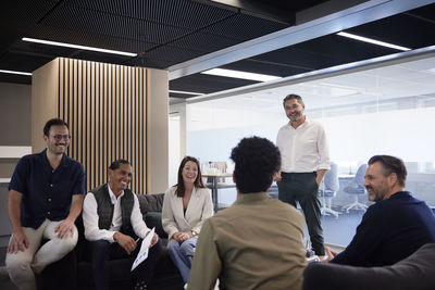 Group of business people having meeting in lobby