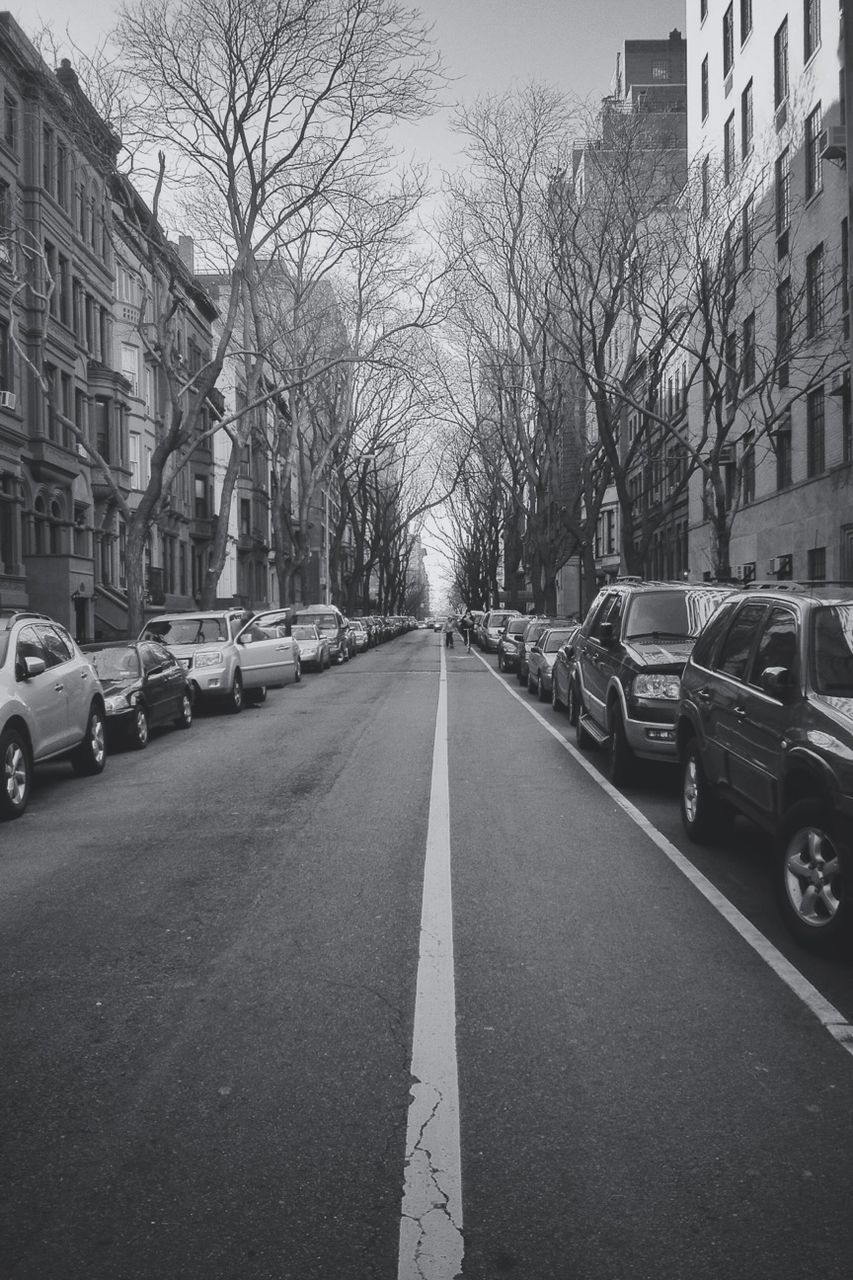 transportation, car, building exterior, land vehicle, architecture, mode of transport, street, built structure, city, the way forward, road, diminishing perspective, road marking, vanishing point, bare tree, city street, tree, city life, parking, building