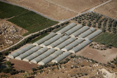 Aerial view of greenhouses and field